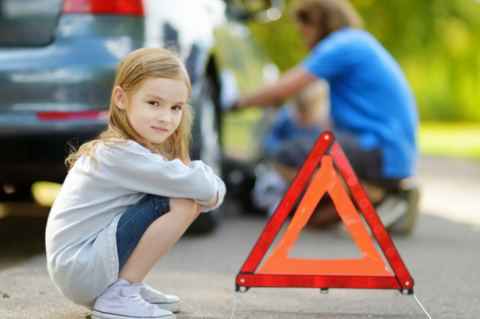 Girl by broken down car